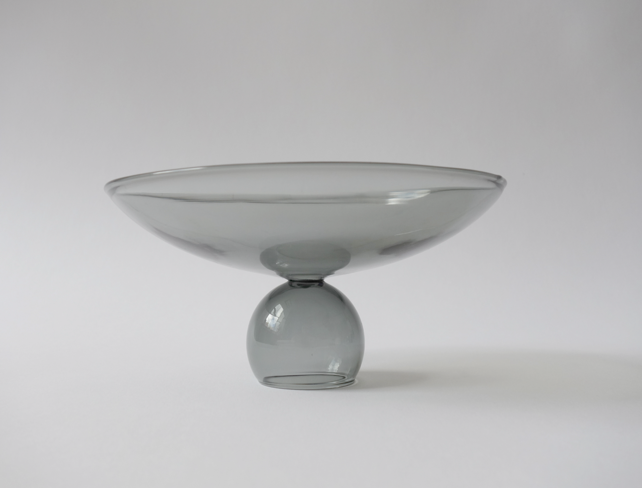smoke colored glass bowl on a white background