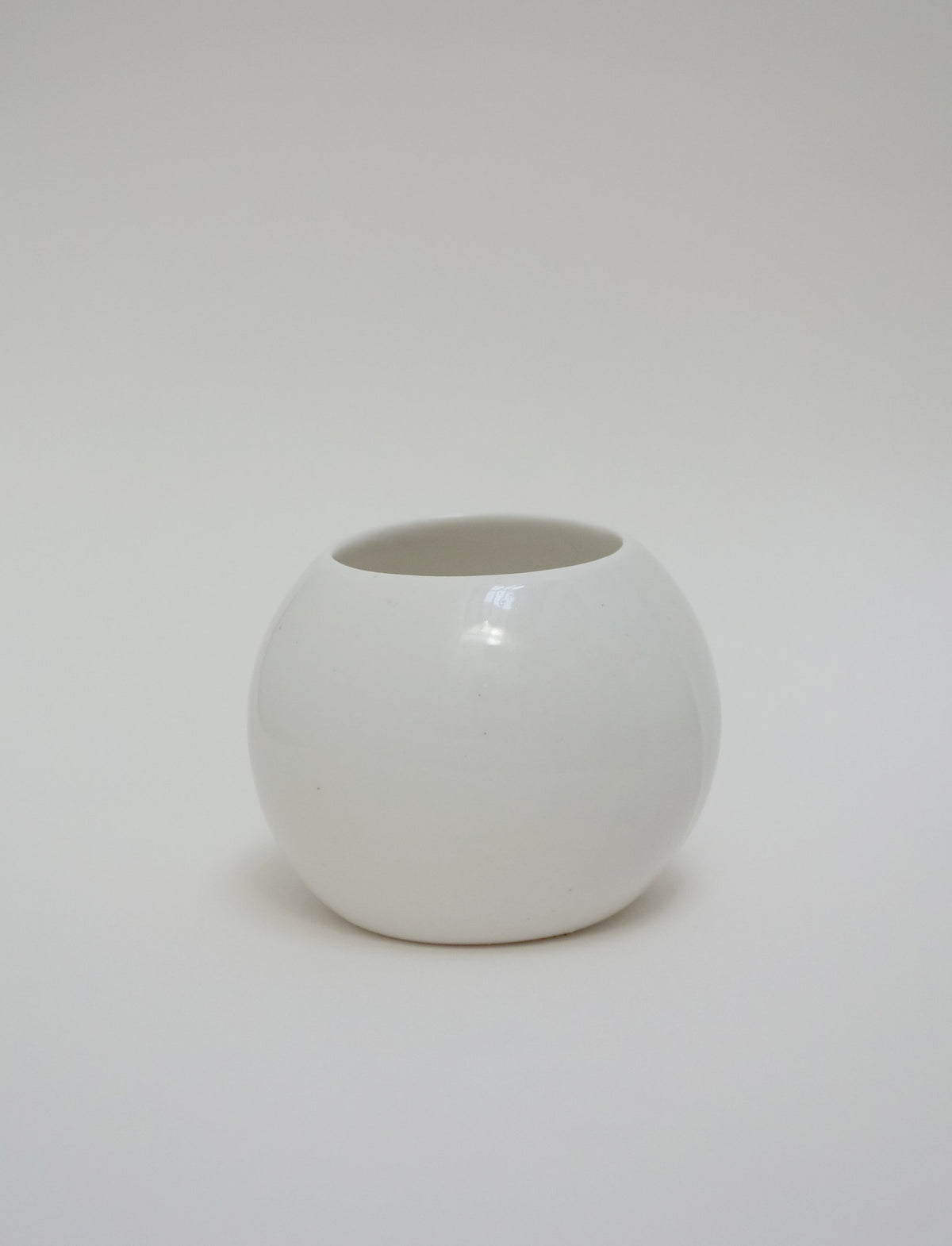 White spherical porcelain bangle on a white background