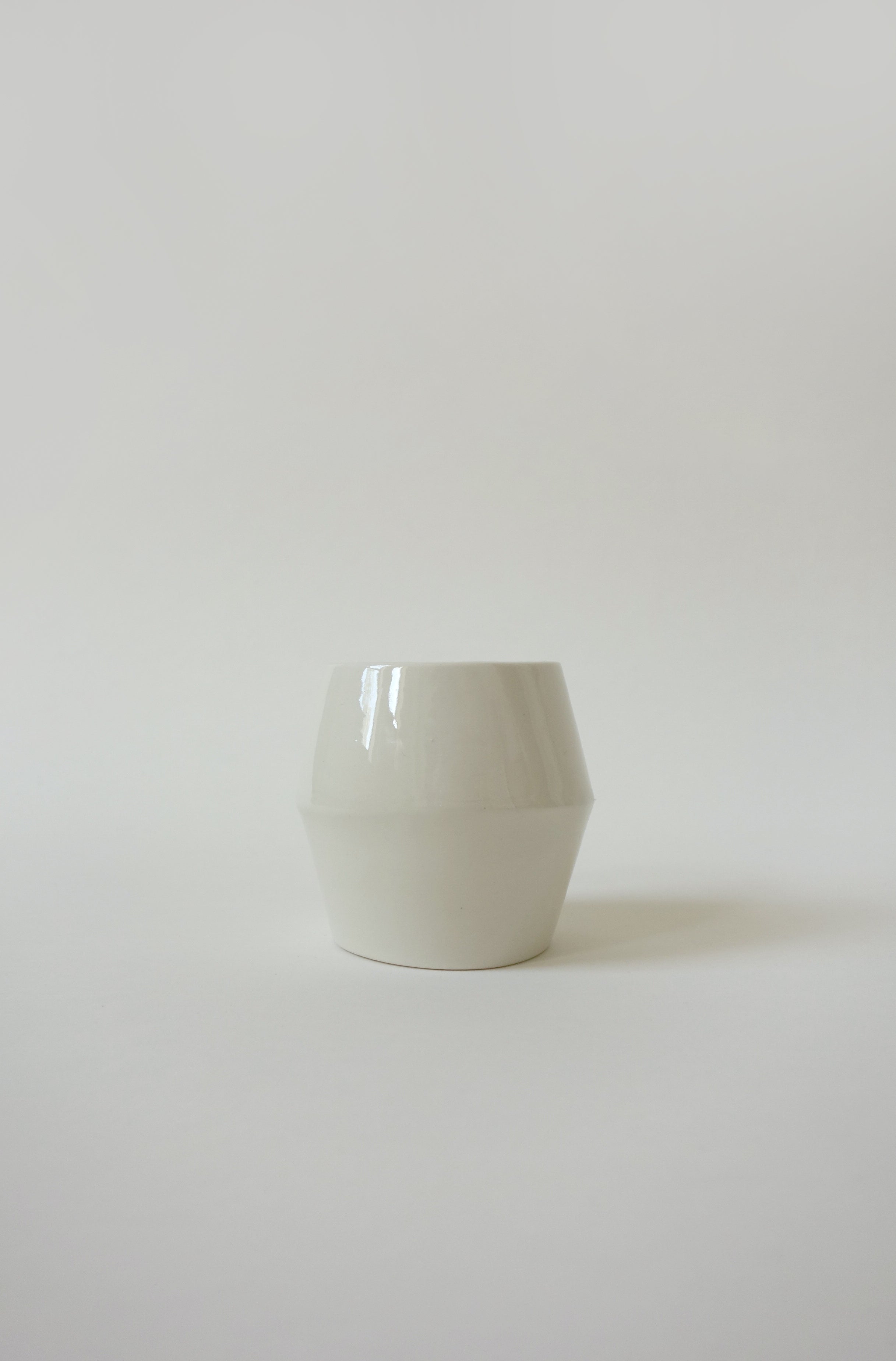 White ceramic bangle on a light gray background
