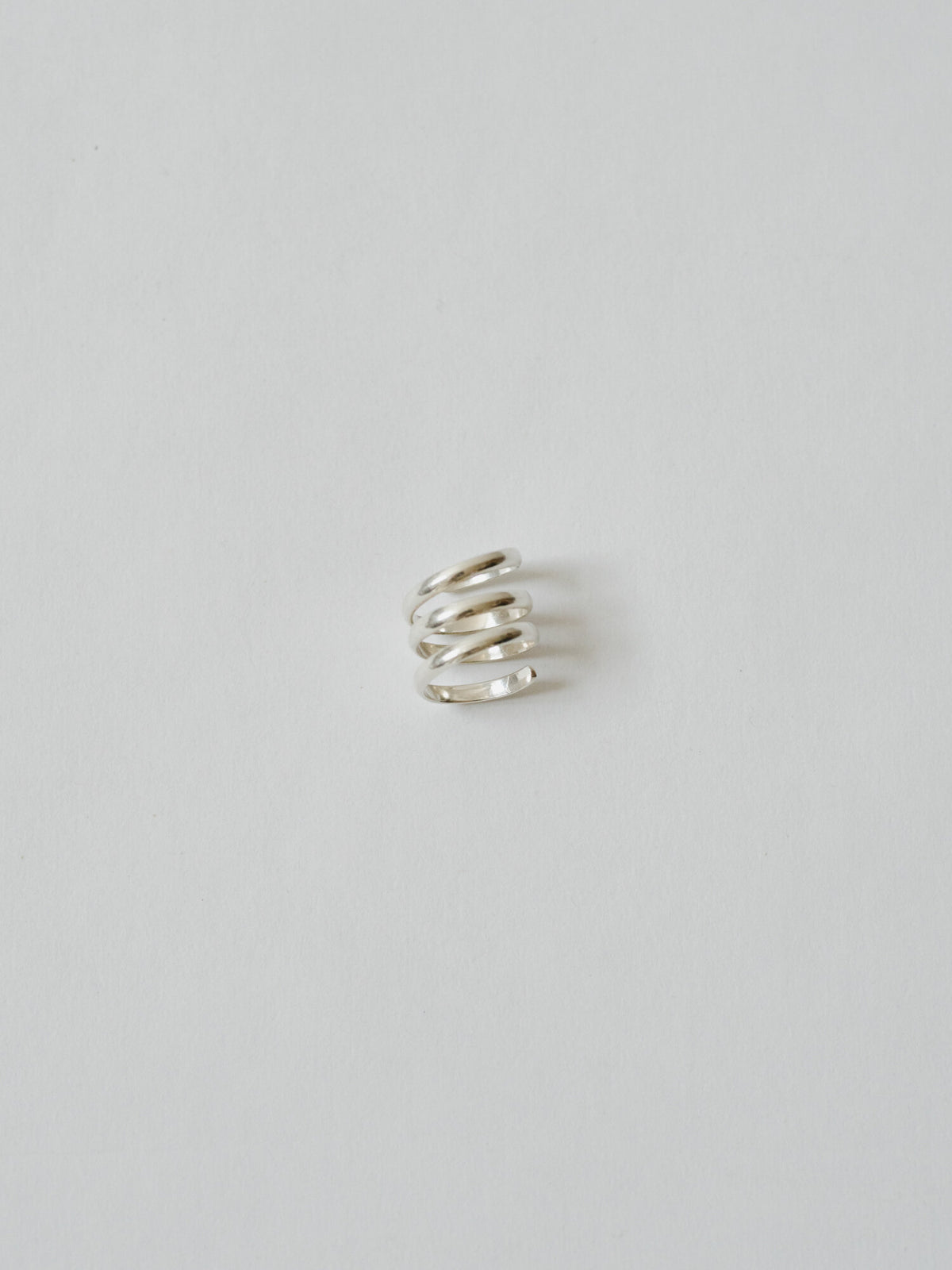 Silver spiral ring on a light gray background