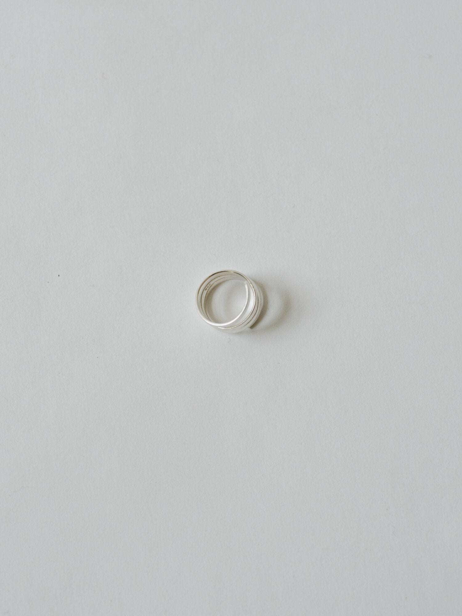 Silver ring on a light gray background